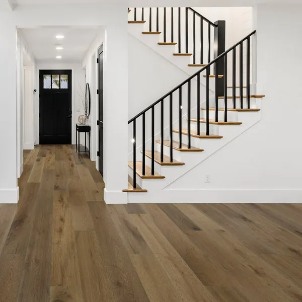 Stairway scene - white room with steps going upstairs. Wood-look flooring.