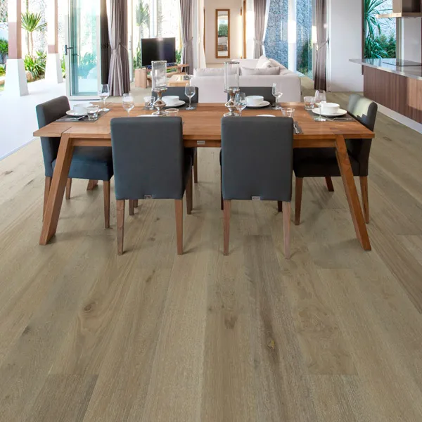 Dining room scene - 6 blue chairs around a rood table. Large room with wood plan flooring.