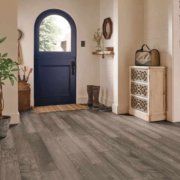 Entry scene - Blue door, cream colored walls and varied grey wood-look floor.