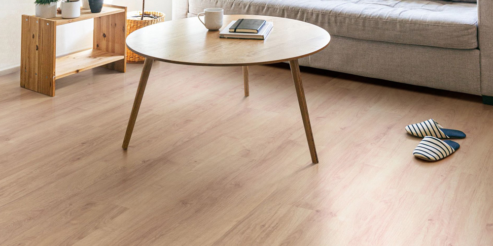 Living room scene with wood-look laminate flooring.