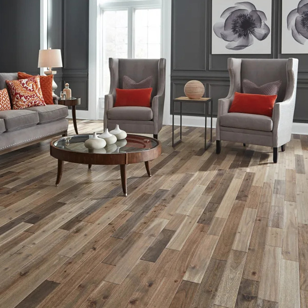 Living room scene with grey furniture and hardwood flooring.