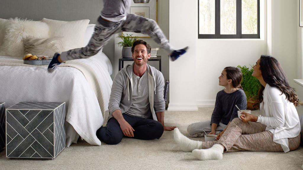 Bedroom scene with family, carpet flooring